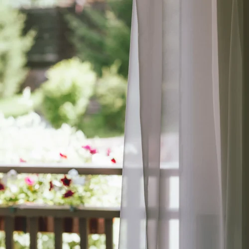 white-curtain-on-the-window-overlooking-the-backya-2026-01-05-05-26-18-utc